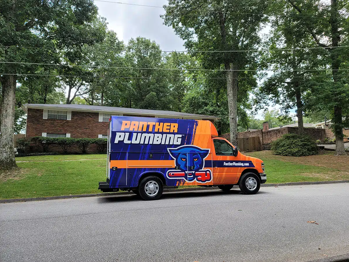 The Panther Plumbing truck parked in front of a residential home in Austell, GA.