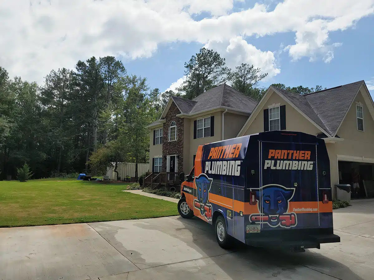 The Panther Plumbing truck parked in the driveway of a residential home in Marietta, GA.