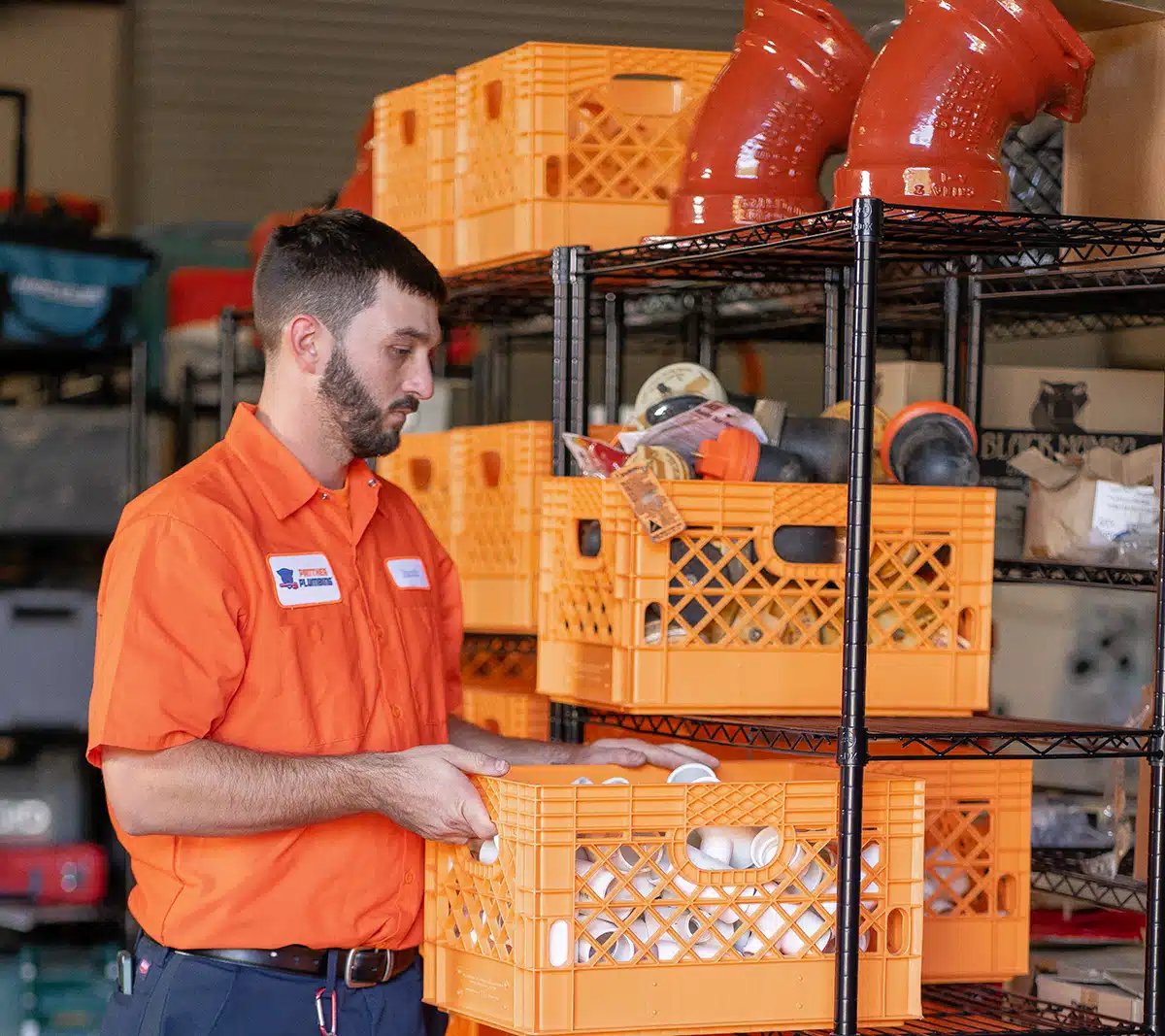 A Panther Plumbing Technician in the warehouse stocking shelves.