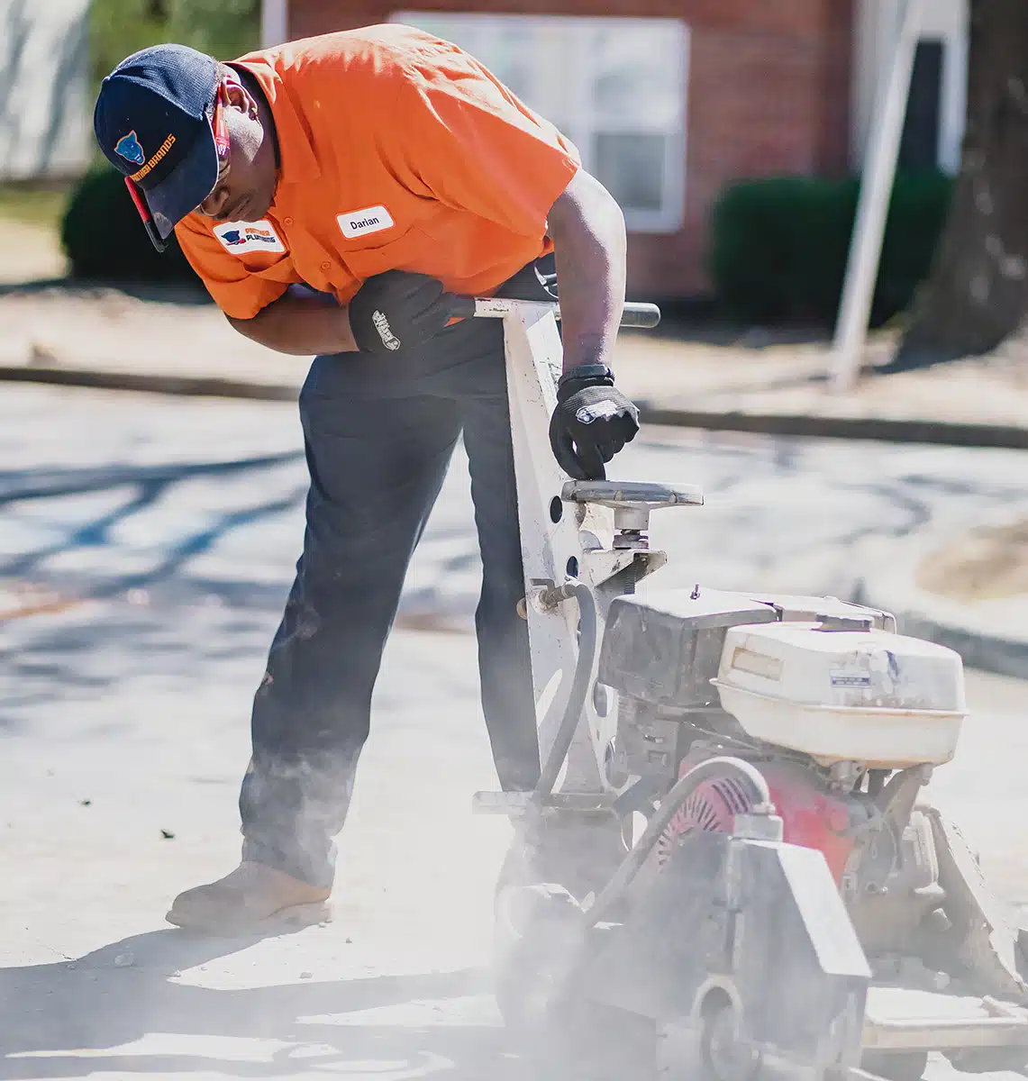 Plumber in Austell, GA cutting concrete for a slab leak.